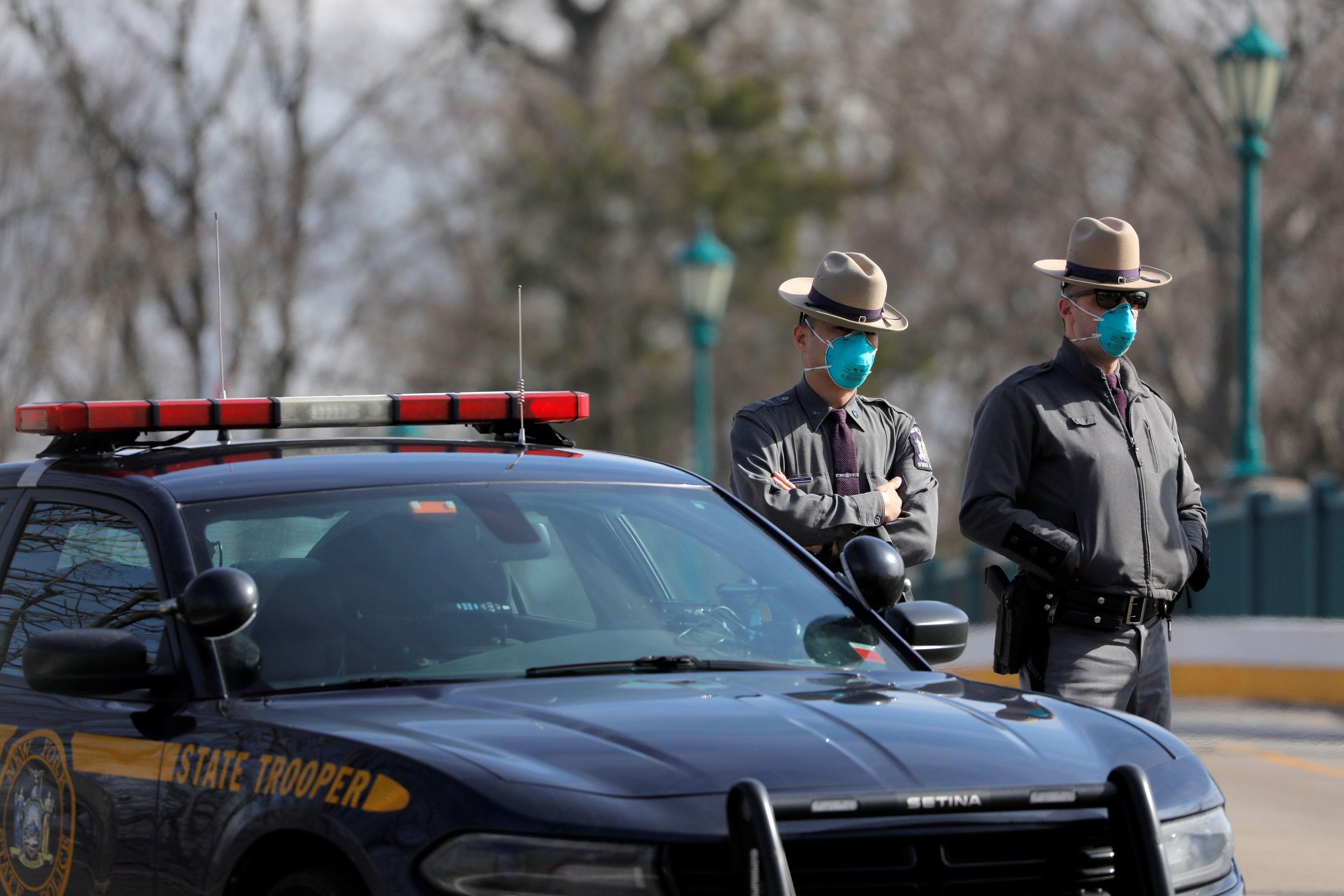 Police officers work at the check point of a testing facility for coronavirus in New Rochelle, Westchester County, New York, U.S., March 16, 2020. REUTERS/Andrew Kelly